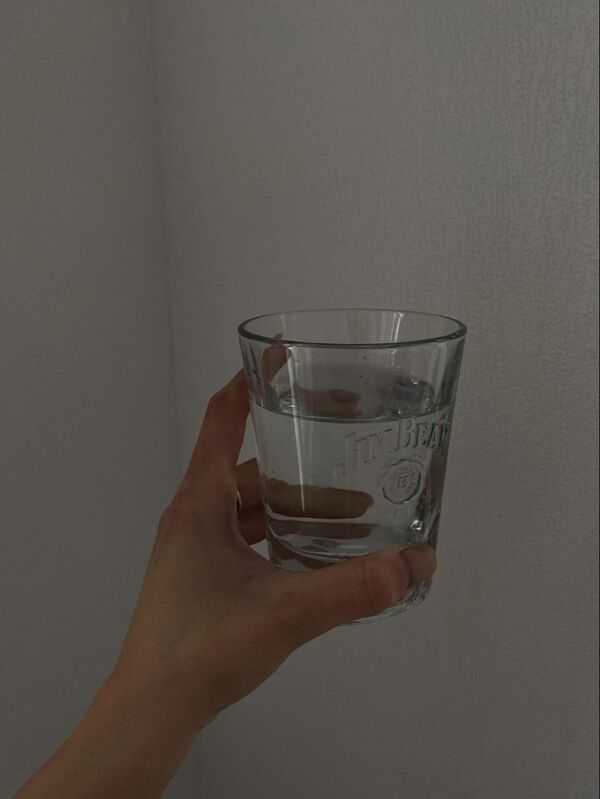 A glass of water on a bright table with a clean, minimal look